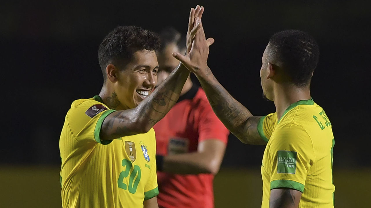 Brazil's Roberto Firmino (L) celebrates with teammate Gabriel Jesus after scoring against Venezuela during their closed-door 2022 FIFA World Cup South American qualifier football match at Morumbi Stadium in Sao Paulo, Brazil, on November 13, 2020.