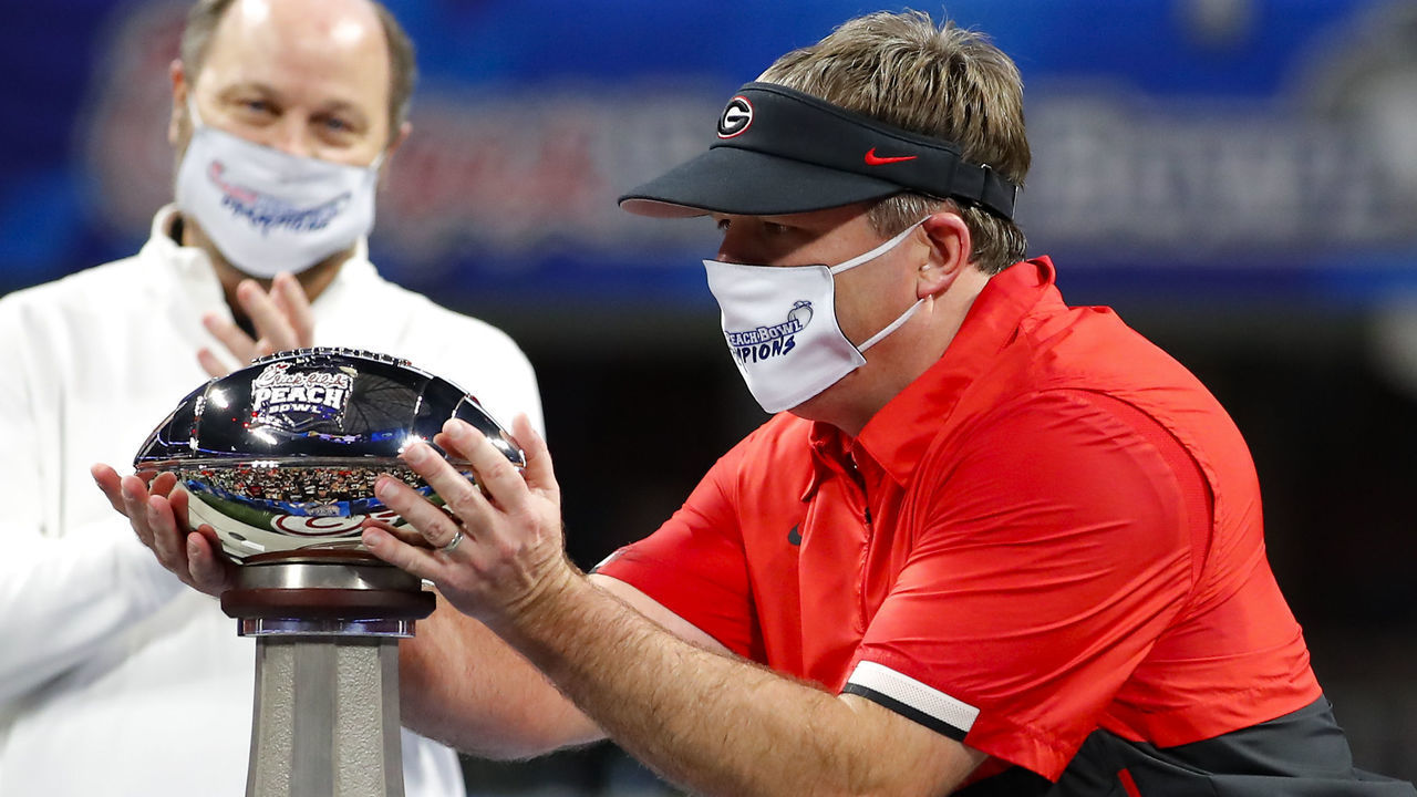 ATLANTA, GA - JANUARY 01: Head coach Kirby Smart of the Georgia Bulldogs accepts the Peach Bowl Champions trophy after the Chick-fil-A Peach Bowl against the Cincinnati Bearcats at Mercedes-Benz Stadium on January 1, 2021 in Atlanta, Georgia.