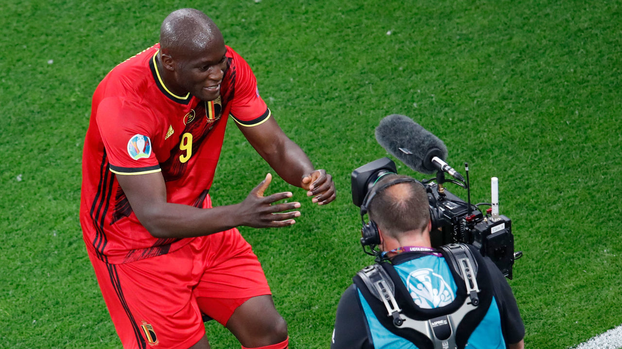 Belgium's forward Romelu Lukaku (L) celebrates in front of a camera after scoring his team's first goal during the UEFA EURO 2020 Group B football match between Belgium and Russia at the Saint Petersburg Stadium in Saint Petersburg on June 12, 2021.