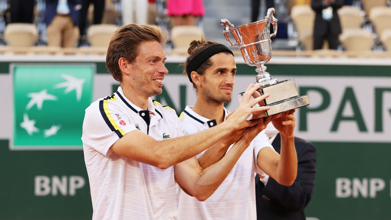 PARIS, FRANCE - JUNE 12: Pierre-Hugues Herbert and Nicolas Mahut of France celebrate with their Trophy after winning the Men's Double's Final on day fourteen of the 2021 French Open at Roland Garros on June 12, 2021 in Paris, France.