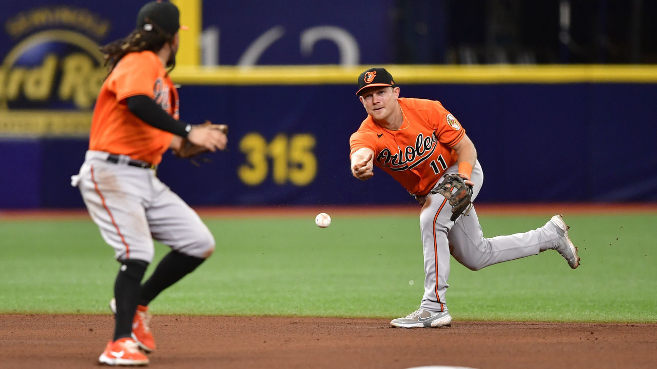 ST PETERSBURG, FLORIDA - JUNE 12: Pat Valaika #11 of the Baltimore Orioles flips the ball to Freddy Galvis #2 during the fourth inning against the Tampa Bay Rays at Tropicana Field on June 12, 2021 in St Petersburg, Florida.
