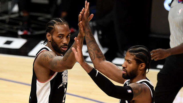 Los Angeles, CA - June 12: Paul George #13 high fives teammate Kawhi Leonard #2 of the LA Clippers after scoring against the Utah Jazz in the fourth quarter of game three of the Western Conference second-round NBA basketball playoff basketball game at the Staples Center in Los Angeles on Saturday, June 12, 2021.