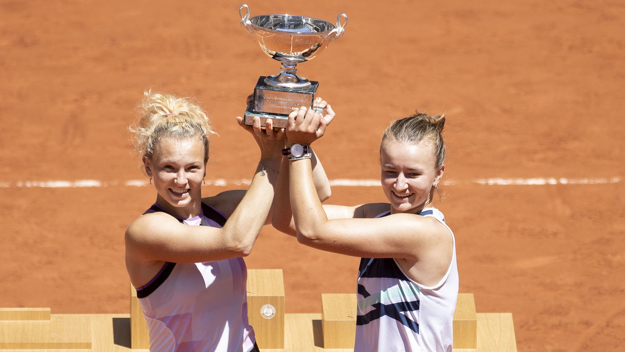 PARIS, FRANCE June 13. Barbora Krejcikova and Katerina Siniakova of the Czech Republic with the winners trophy after their victory against Bethanie Mattek-Sands of the United States and Iga Swiatek of Poland on Court Philippe-Chatrier during the final of the doubles competition at the 2021 French Open Tennis Tournament at Roland Garros on June 13th 2021 in Paris, France.