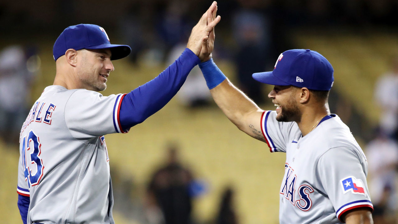 LOS ANGELES, CALIFORNIA - JUNE 12: Jason Martin #50 and first base coach Corey Ragsdale #43 of the Texas Rangers celebrate their 12-1 win against the Los Angeles Dodgers after the game at Dodger Stadium on June 12, 2021 in Los Angeles, California.