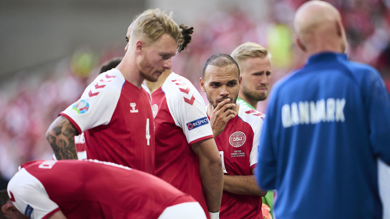 COPENHAGEN, DENMARK - JUNE 12: Simon Kjar, Martin Braithwaite and Kasper Schmeichel of Denmark showing emotions watching the medical treatment of Christian Eriksen during the UEFA EURO 2020 Group B match between Denmark and Finland at Parken Stadium on June 12, 2021 in Copenhagen, Denmark.