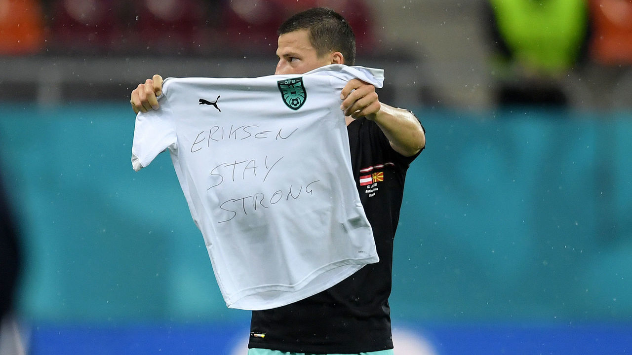 BUCHAREST, ROMANIA - JUNE 13: Stefan Lainer of Austria celebrates after scoring their side's first goal whilst holding a t-shirt with a message of support for Christian Eriksen of Denmark (not pictured) during the UEFA Euro 2020 Championship Group C match between Austria and North Macedonia at National Arena Bucharest on June 13, 2021 in Bucharest, Romania.