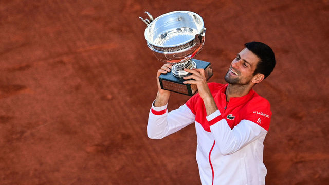 TOPSHOT - Serbia's Novak Djokovic poses with The Mousquetaires Cup (The Musketeers) after winning against Greece's Stefanos Tsitsipas at the end of their men's final tennis match on Day 15 of The Roland Garros 2021 French Open tennis tournament in Paris on June 13, 2021.