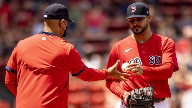 BOSTON, MA - JUNE 13: Martin Perez #54 of the Boston Red Sox hands the ball to manager Alex Cora as he exits the game during the second inning against the Toronto Blue Jays on June 13, 2021 at Fenway Park in Boston, Massachusetts.