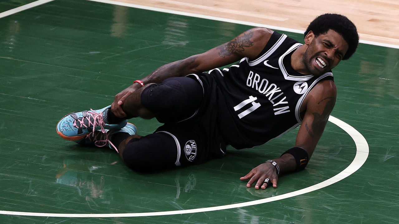 MILWAUKEE, WISCONSIN - JUNE 13: Kyrie Irving #11 of the Brooklyn Nets is injured during the first half of Game Four of the Eastern Conference second round playoff series against the Milwaukee Bucks at the Fiserv Forum on June 13, 2021 in Milwaukee, Wisconsin.