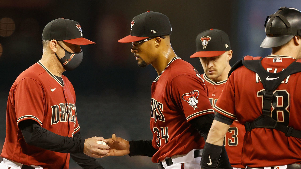 PHOENIX, ARIZONA - JUNE 13: Starting pitcher Jon Duplantier #34 of the Arizona Diamondbacks is removed by manager Torey Lovullo #17 during the second inning of the MLB game against the Los Angeles Angels at Chase Field on June 13, 2021 in Phoenix, Arizona.