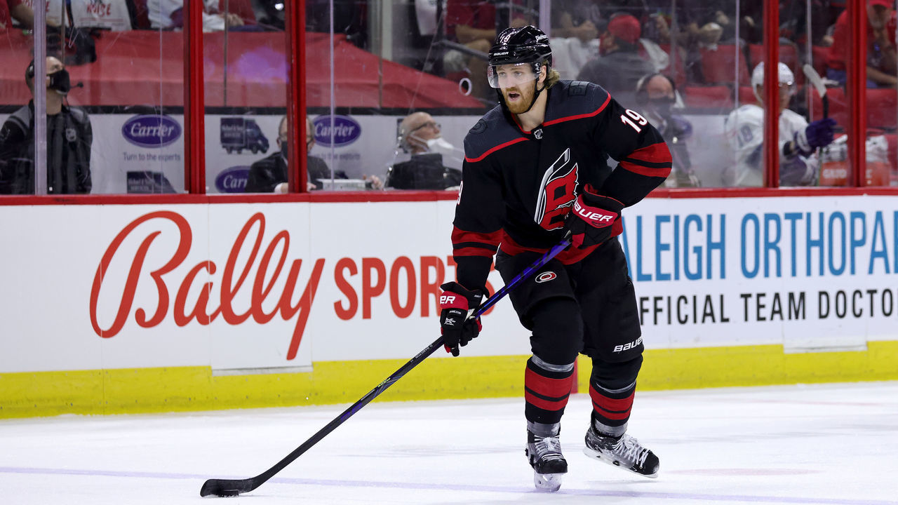 RALEIGH, NC - JUNE 8:Dougie Hamilton #19 of the Carolina Hurricanes skates for position on the ice with the puck in Game Five of the Second Round of the 2021 Stanley Cup Playoffs against the Tampa Bay Lighting on June 8, 2021 at PNC Arena in Raleigh, North Carolina.