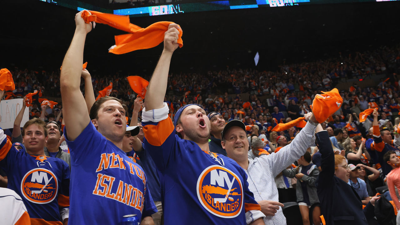 UNIONDALE, NEW YORK - JUNE 09: New York Islanders fans celebrate during the game against the Boston Bruins in Game Six of the Second Round of the 2021 NHL Stanley Cup Playoffs at the Nassau Coliseum on June 09, 2021 in Uniondale, New York. The Islanders defeated the Bruins 6-2 to move on to the Stanley Cup Semifinals against the Tampa Bay Lightning.