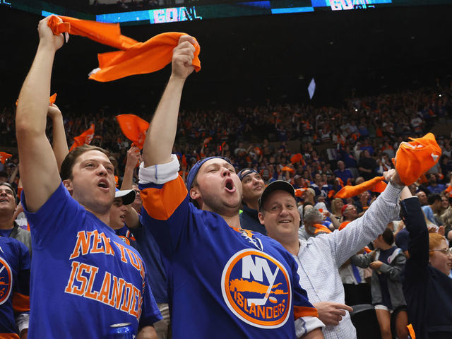 UNIONDALE, NEW YORK - JUNE 09: New York Islanders fans celebrate during the game against the Boston Bruins in Game Six of the Second Round of the 2021 NHL Stanley Cup Playoffs at the Nassau Coliseum on June 09, 2021 in Uniondale, New York. The Islanders defeated the Bruins 6-2 to move on to the Stanley Cup Semifinals against the Tampa Bay Lightning.