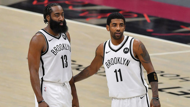 CLEVELAND, OHIO - JANUARY 20: James Harden #13 talks with Kyrie Irving #11 of the Brooklyn Nets during the fourth quarter against the Cleveland Cavaliers at Rocket Mortgage Fieldhouse on January 20, 2021 in Cleveland, Ohio. NOTE TO USER: User expressly acknowledges and agrees that, by downloading and/or using this photograph, user is consenting to the terms and conditions of the Getty Images License Agreement.