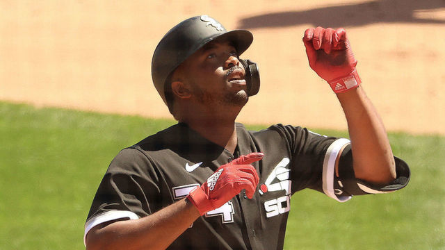 GLENDALE, ARIZONA - MARCH 22: Eloy Jimenez #74 of the Chicago White Sox celebrates while crossing home plate after hitting a solo home run in the first inning against the San Francisco Giants during the MLB spring training game at Camelback Ranch on March 22, 2021 in Glendale, Arizona.