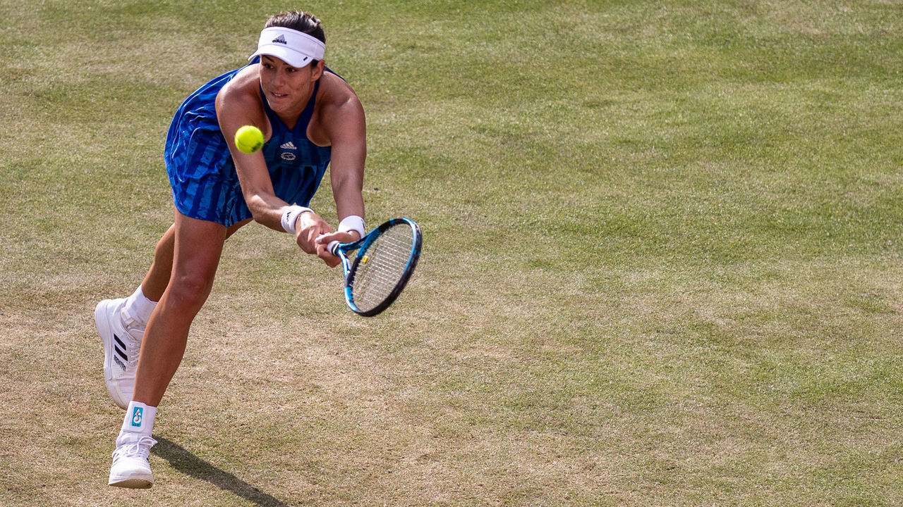 BERLIN, GERMANY - JUNE 15: Garbine Muguruza of Spain streches to play a backhand against Sorana Cirstea of Romania in the women's singles match during day 4 of the bett1open at LTTC Rot-Weiß e.V. on June 15, 2021 in Berlin, Germany.