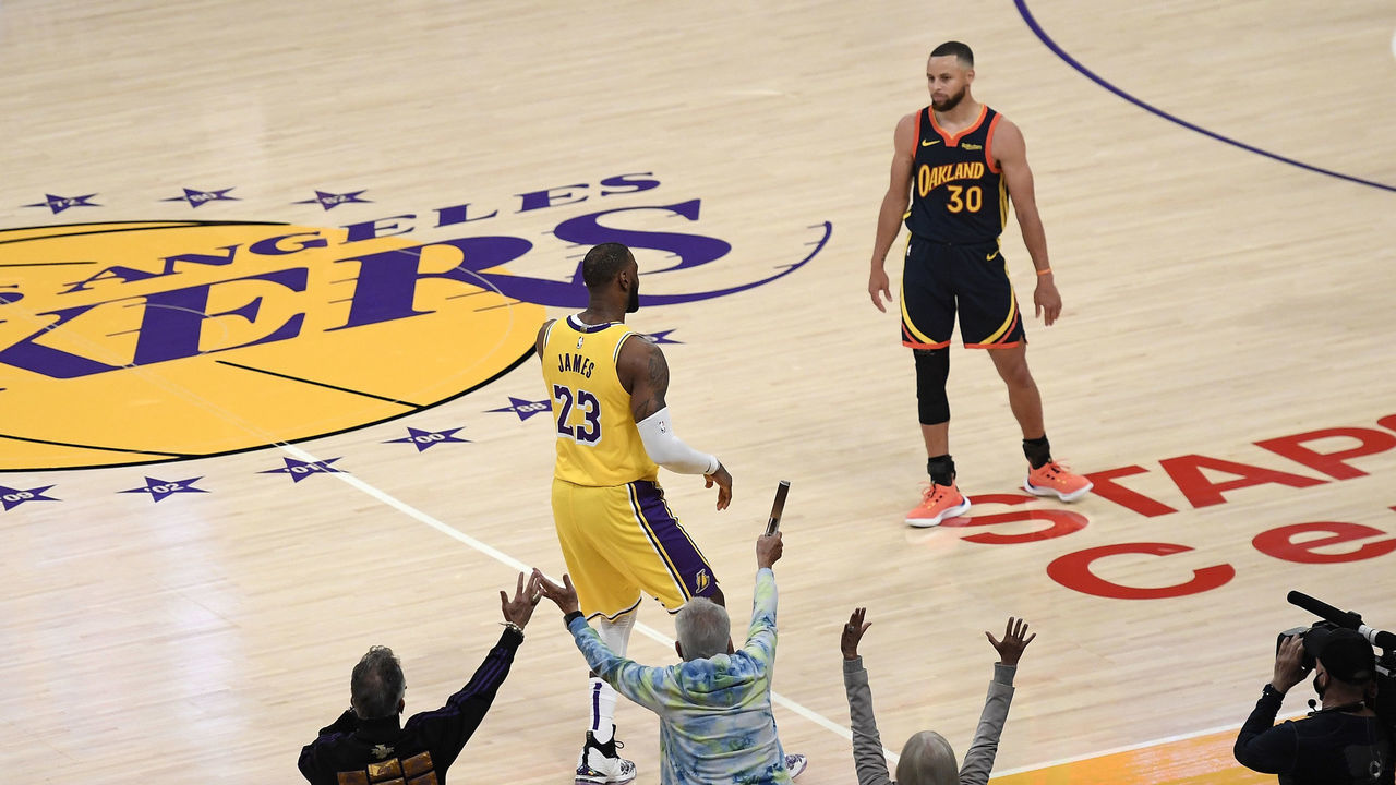 LOS ANGELES, CA - MAY 19: LeBron James #23 of the Los Angeles Lakers scores the game winning three point basket against Stephen Curry #30 of the Golden State Warriors in the closing minute of an NBA Play-In Tournament at Staples Center on May 19, 2021 in Los Angeles, California.