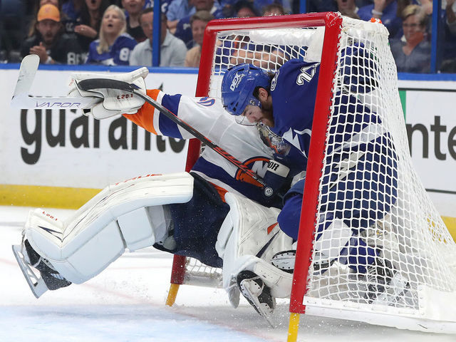 TAMPA, FLORIDA - JUNE 15: Brayden Point #21 of the Tampa Bay Lightning collides with Semyon Varlamov #40 of the New York Islanders in the net during the first period in Game Two of the Stanley Cup Semifinals in the 2021 Stanley Cup Playoffs at Amalie Arena on June 15, 2021 in Tampa, Florida.