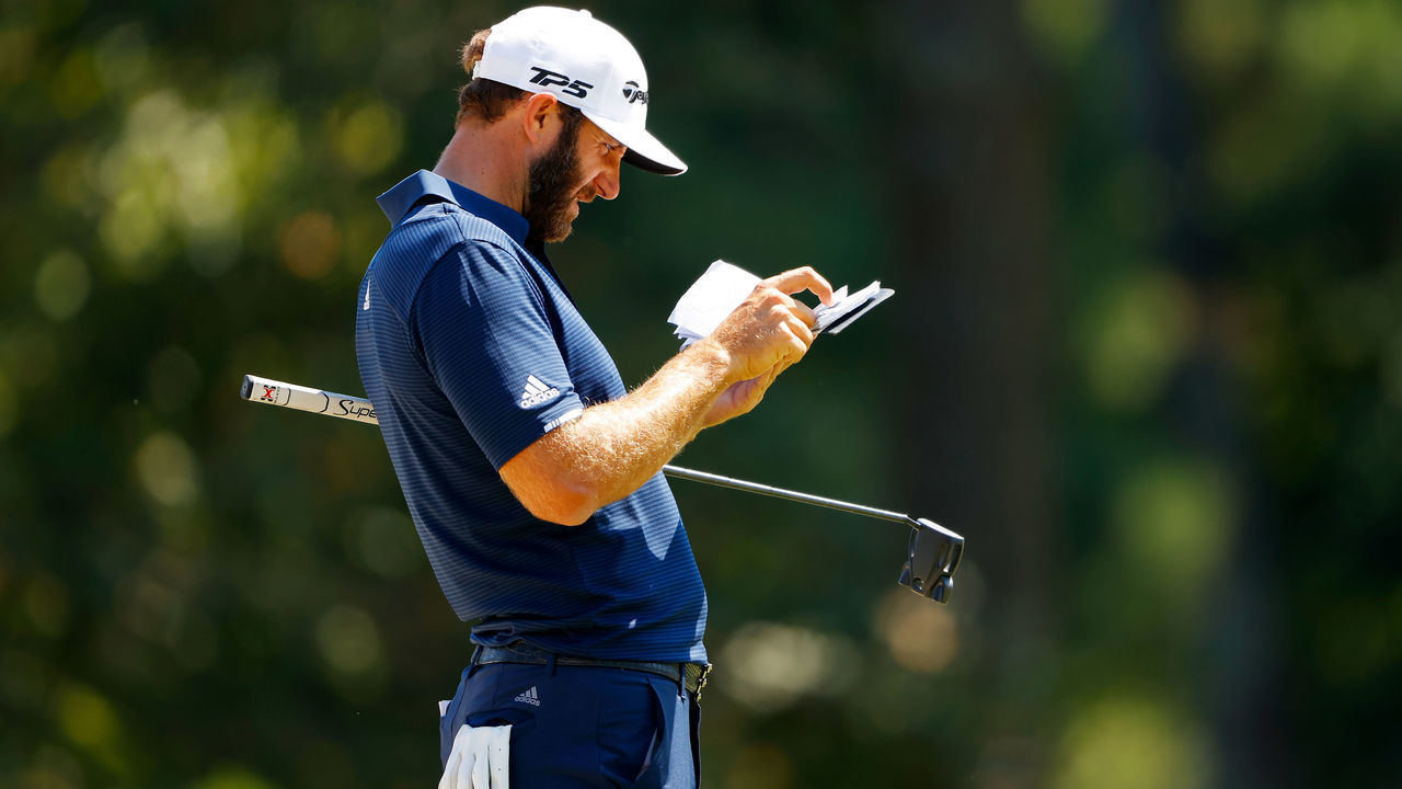 ATLANTA, GEORGIA - SEPTEMBER 07: Dustin Johnson of the United States checks his yardage book on the third green during the final round of the TOUR Championship at East Lake Golf Club on September 07, 2020 in Atlanta, Georgia.
