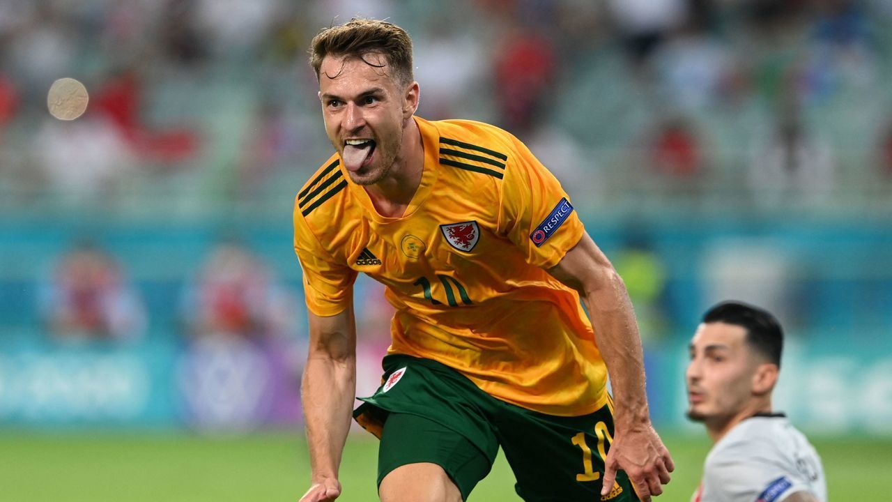 Wales' midfielder Aaron Ramsey (L) celebrates after scoring the opening goal during the UEFA EURO 2020 Group A football match between Turkey and Wales at the Olympic Stadium in Baku on June 16, 2021.