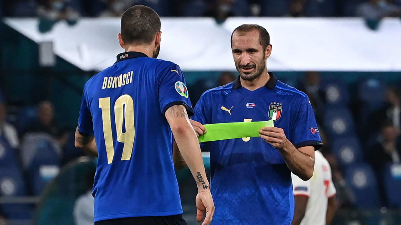Italy's defender Giorgio Chiellini (R) passes the captain's armband to Italy's defender Leonardo Bonucci before leaving the pitch due to injury during the UEFA EURO 2020 Group A football match between Italy and Switzerland at the Olympic Stadium in Rome on June 16, 2021.