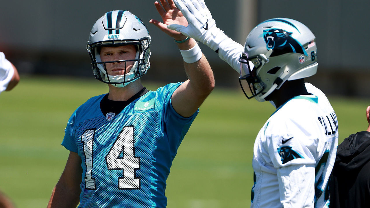 CHARLOTTE, NORTH CAROLINA - JUNE 15: Sam Darnold #14 high-fives Stephen Sullivan #84 of the Carolina Panthers during mandatory minicamp at Bank of America Stadium on June 15, 2021 in Charlotte, North Carolina.