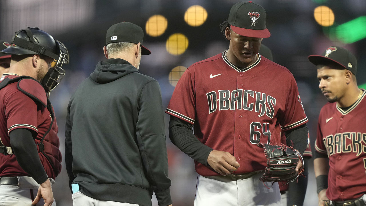 SAN FRANCISCO, CALIFORNIA - JUNE 16: Manager Torey Lovullo #17 of the Arizona Diamondbacks takes the ball from Keury Mella #64 taking him out of the game against the San Francisco Giants in the bottom of the fourth inning at Oracle Park on June 16, 2021 in San Francisco, California.