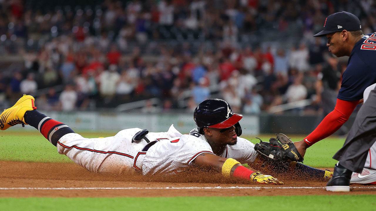 ATLANTA, GEORGIA - JUNE 16: Ronald Acuna Jr. #13 of the Atlanta Braves is tagged out by Rafael Devers #11 of the Boston Red Sox as he slides into third base after attempting to advance on a RBI double in the ninth inning at Truist Park on June 16, 2021 in Atlanta, Georgia.