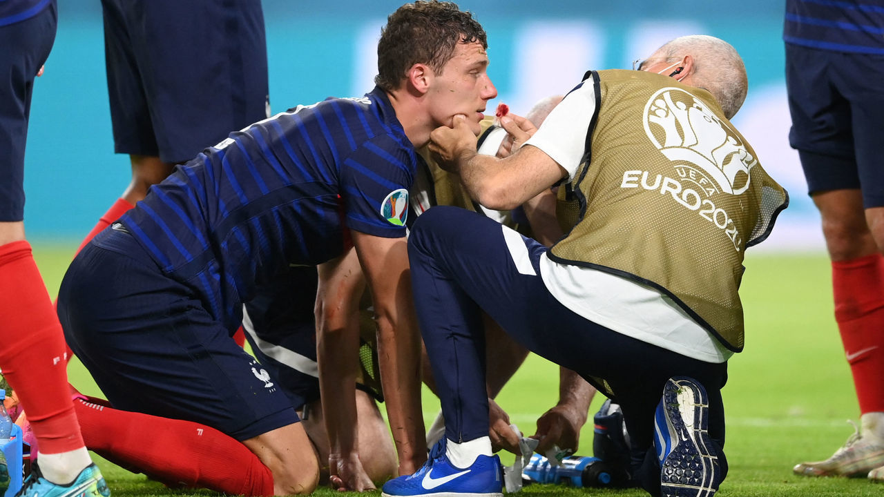 France's defender Benjamin Pavard receives treatment after a collision during the UEFA EURO 2020 Group F football match between France and Germany at the Allianz Arena in Munich on June 15, 2021.