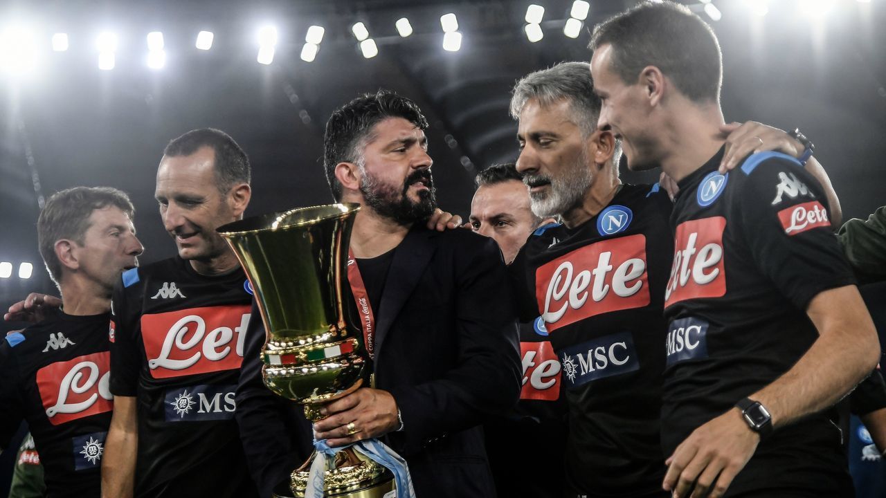 Napoli's Italian head coach Gennaro Gattuso (C with trophy) celebrates with his staff after Napoli won the TIM Italian Cup (Coppa Italia) final football match Napoli vs Juventus on June 17, 2020 at the Olympic stadium in Rome, played behind closed doors as the country gradually eases the lockdown aimed at curbing the spread of the COVID-19 infection, caused by the novel coronavirus.