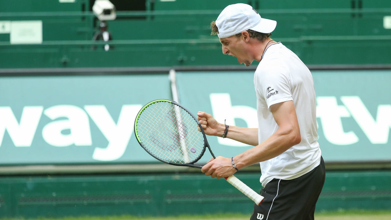17 June 2021, North Rhine-Westphalia, Halle: Tennis: ATP Tour Singles, Men, Round of 16, Zverev (Germany) - Humbert (France). Ugo Humbert clenches his fist after his victory. Photo: Friso Gentsch/dpa