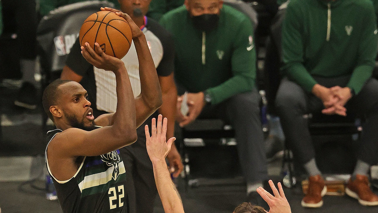 MILWAUKEE, WISCONSIN - JUNE 17: Khris Middleton #22 of the Milwaukee Bucks shoots over Joe Harris #12 of the Brooklyn Nets at Fiserv Forum on June 17, 2021 in Milwaukee, Wisconsin.