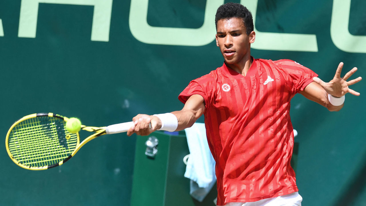 Canada's Felix Auger-Aliassime returns the ball to Marcos Giron from the USA during their men's quarter-final singles match of the ATP 500 Halle Open tennis tournament in Halle, western Germany, on June 18, 2021.