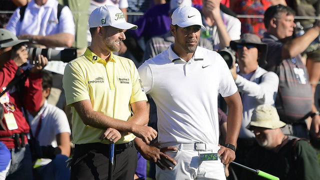 SCOTTSDALE, ARIZONA - FEBRUARY 02: Webb Simpson (L) and Tony Finau speak as they wait to approach the green on the 18th hole during the final round of the Waste Management Phoenix Open at TPC Scottsdale on February 02, 2020 in Scottsdale, Arizona.