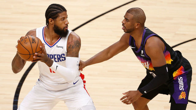 PHOENIX, ARIZONA - APRIL 28: Paul George #13 of the LA Clippers handles the ball against Chris Paul #3 of the Phoenix Suns during the NBA game at Phoenix Suns Arena on April 28, 2021 in Phoenix, Arizona. The Suns defeated the Clippers 109-101.