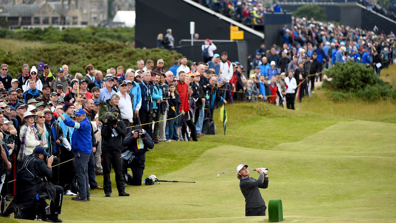 ST ANDREWS, SCOTLAND - JULY 17: Tommy Fleetwood of England plays his second shot on the fourth hole as a gallery of fans look on during the second round of the 144th Open Championship at The Old Course on July 17, 2015 in St Andrews, Scotland.