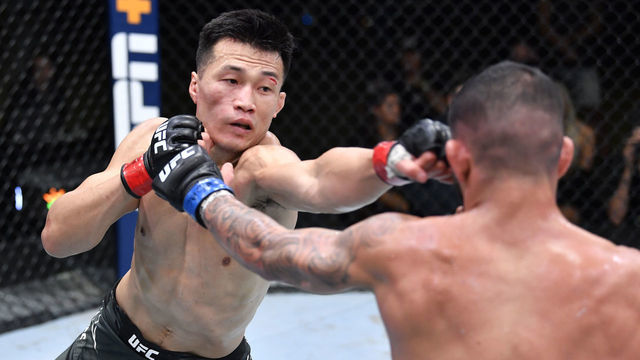 LAS VEGAS, NEVADA - JUNE 19: (L-R) 'The Korean Zombie' Chan Sung Jung of South Korea punches Dan Ige in a featherweight bout during the UFC Fight Night event at UFC APEX on June 19, 2021 in Las Vegas, Nevada.