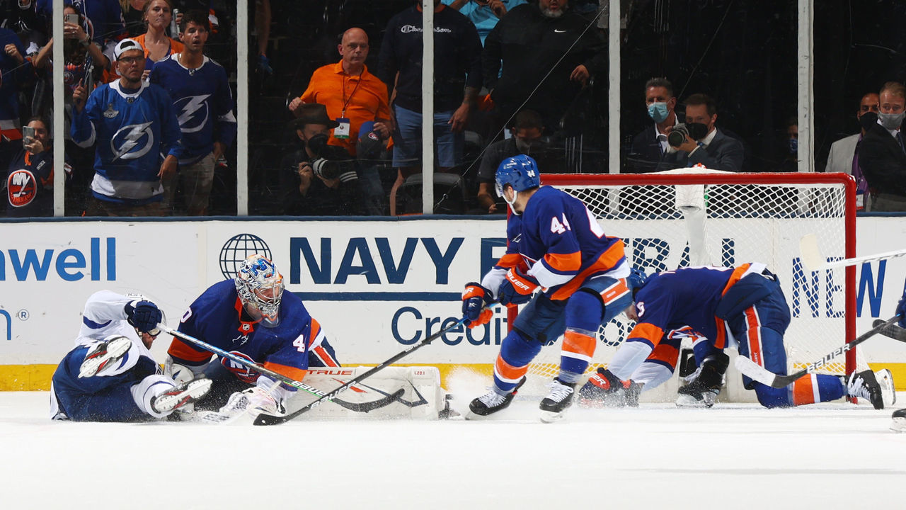 UNIONDALE, NEW YORK - JUNE 19: Ryan Pulock #6 of the New York Islanders dives across the crease to make a save with the net open at the end of the third period against Ryan McDonagh #27 of the Tampa Bay Lightning in Game Four of the Stanley Cup Semifinals of the 2021 Stanley Cup Playoffs at Nassau Coliseum on June 19, 2021 in Uniondale, New York.