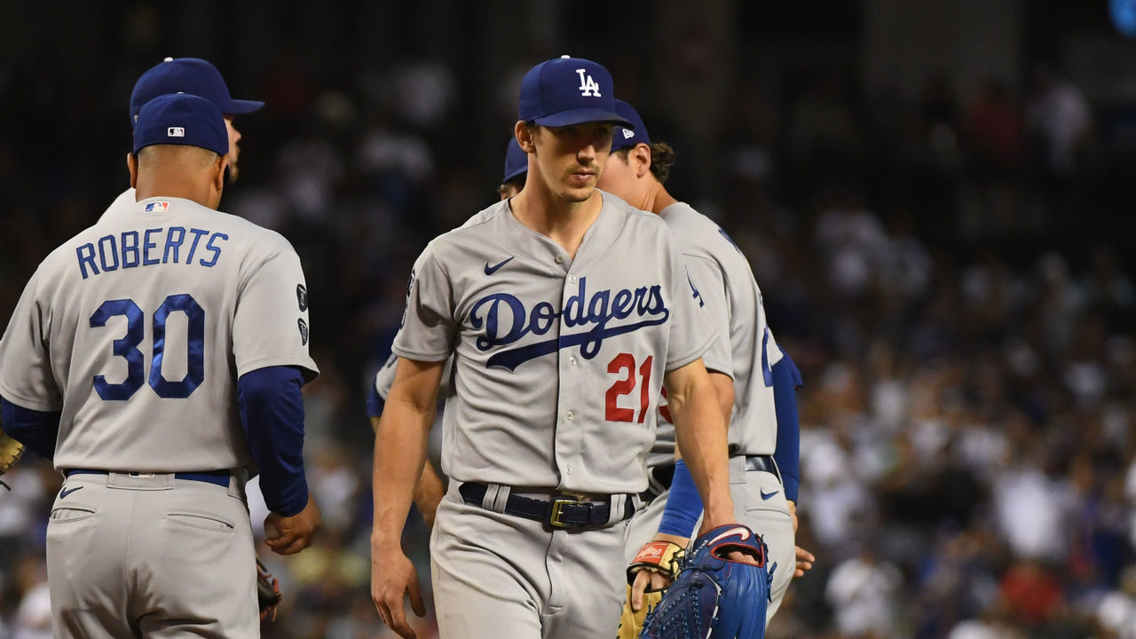 PHOENIX, ARIZONA - JUNE 19: Walker Buehler #21 of the Los Angeles Dodgers is taken out of the game by manager Dave Roberts #30 in the eighth inning after both David Peralta #6 and Nick Ahmed #13 of the Arizona Diamondbacks hit singles to end a no-hit bid at Chase Field on June 19, 2021 in Phoenix, Arizona.