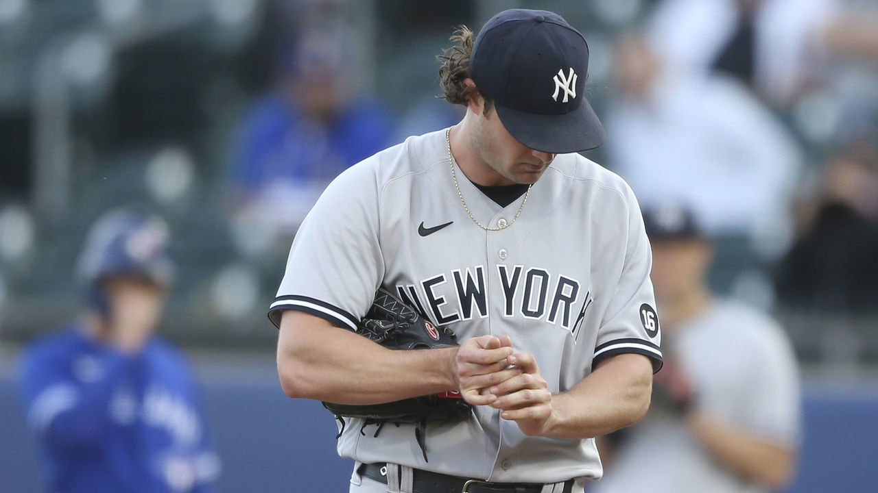 BUFFALO, NEW YORK - JUNE 16: Gerrit Cole #45 of the New York Yankees rubs the ball between pitches during the second inning against the Toronto Blue Jays at Sahlen Field on June 16, 2021 in Buffalo, New York.