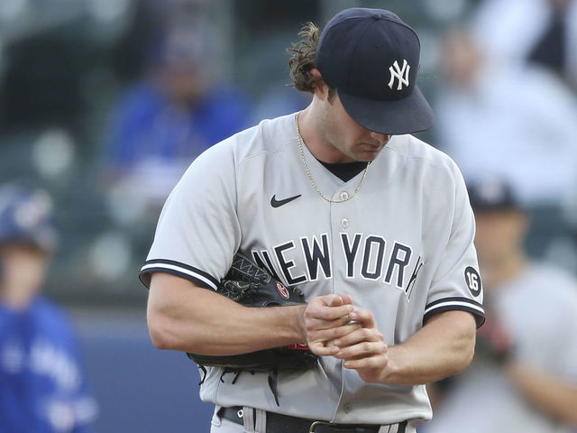 BUFFALO, NEW YORK - JUNE 16: Gerrit Cole #45 of the New York Yankees rubs the ball between pitches during the second inning against the Toronto Blue Jays at Sahlen Field on June 16, 2021 in Buffalo, New York.