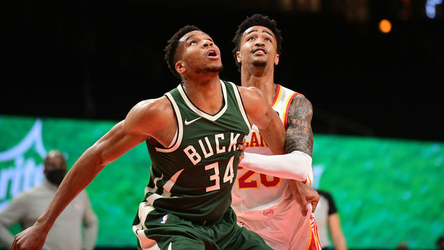 ATLANTA, GA - APRIL 25: Giannis Antetokounmpo #34 of the Milwaukee Bucks fights for position against John Collins #20 of the Atlanta Hawks on April 25, 2021 at State Farm Arena in Atlanta, Georgia. Mandatory Copyright Notice: Copyright 2021 NBAE
