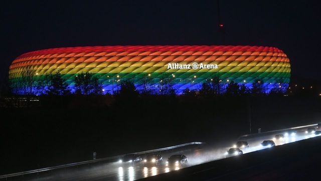 Traffic passes the Allianz Arena illuminated in the rainbow colours after the German first division Bundesliga football match FC Bayern Munich v TSG 1899 Hoffenheim in Munich, southern Germany on January 30, 2021.