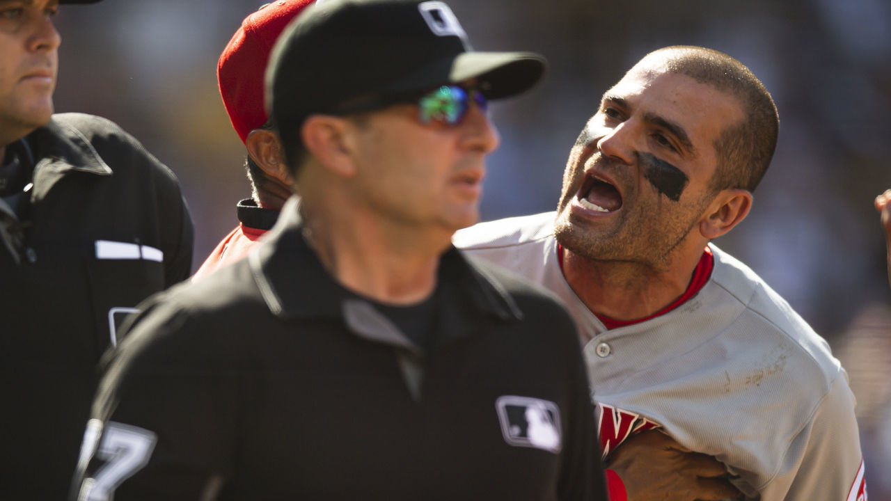 SAN DIEGO, CA - JUNE 19: Joey Votto #19 of the Cincinnati Reds is held back while arguing with the home plate umpire after being ejected against the San Diego Padres on June 19, 2021 at Petco Park in San Diego, California.