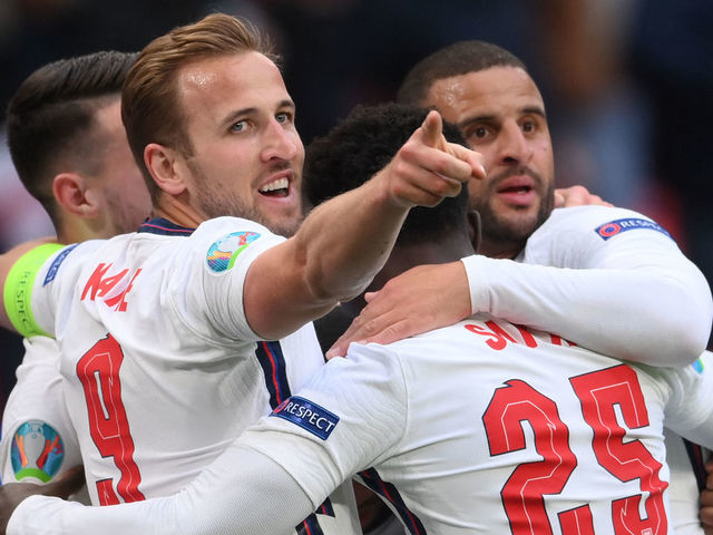 TOPSHOT - England's forward Raheem Sterling (hidden) celebrates scoring the opening goal with his teammates including England's forward Harry Kane, England's midfielder Bukayo Saka and England's defender Kyle Walker during the UEFA EURO 2020 Group D football match between Czech Republic and England at Wembley Stadium in London on June 22, 2021.