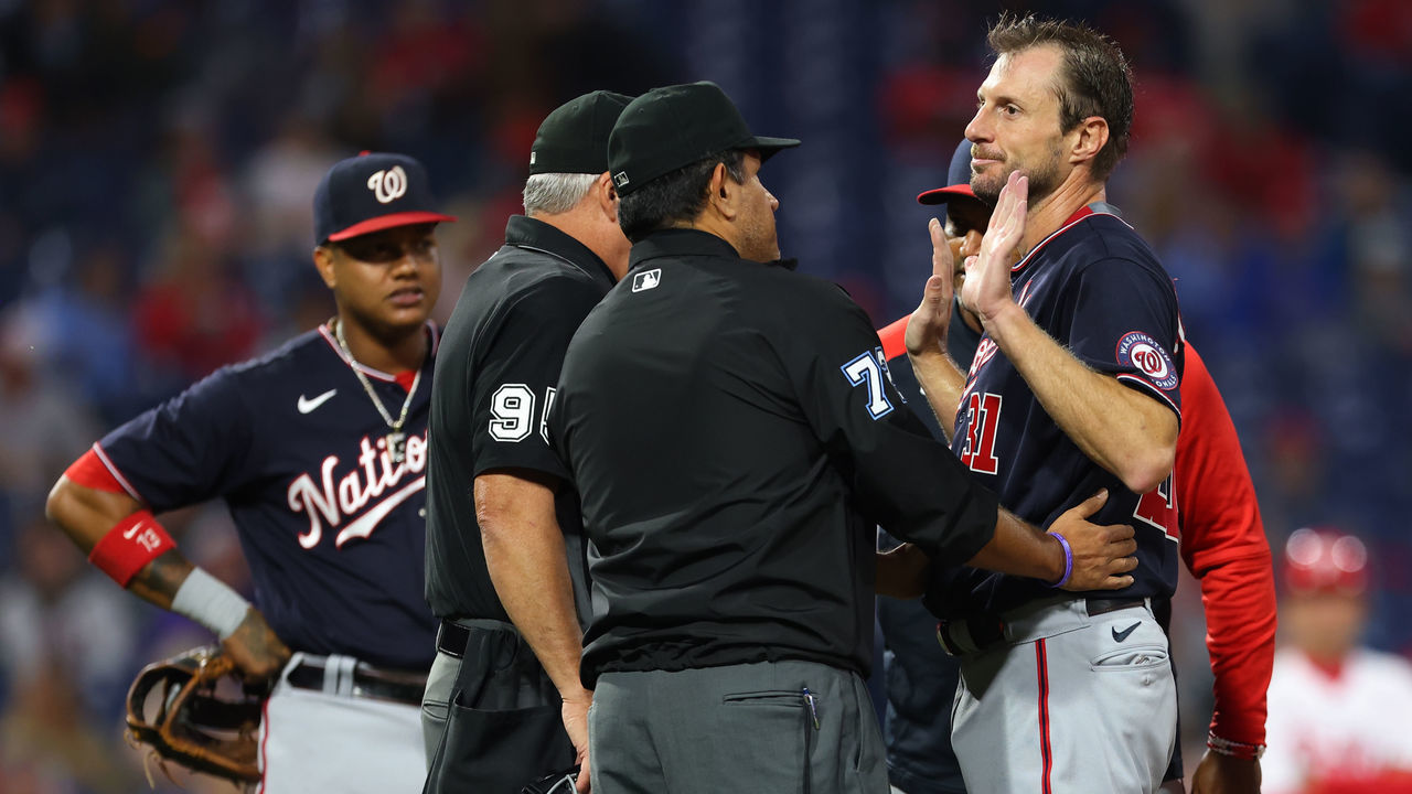 PHILADELPHIA, PA - JUNE 22: Pitcher Max Scherzer #31 of the Washington Nationals is searched for foreign substances by umpires Tim Timmons #95 and Alfonso Marquez #72 during the fourth inning of a game against the Philadelphia Phillies at Citizens Bank Park on June 22, 2021 in Philadelphia, Pennsylvania.