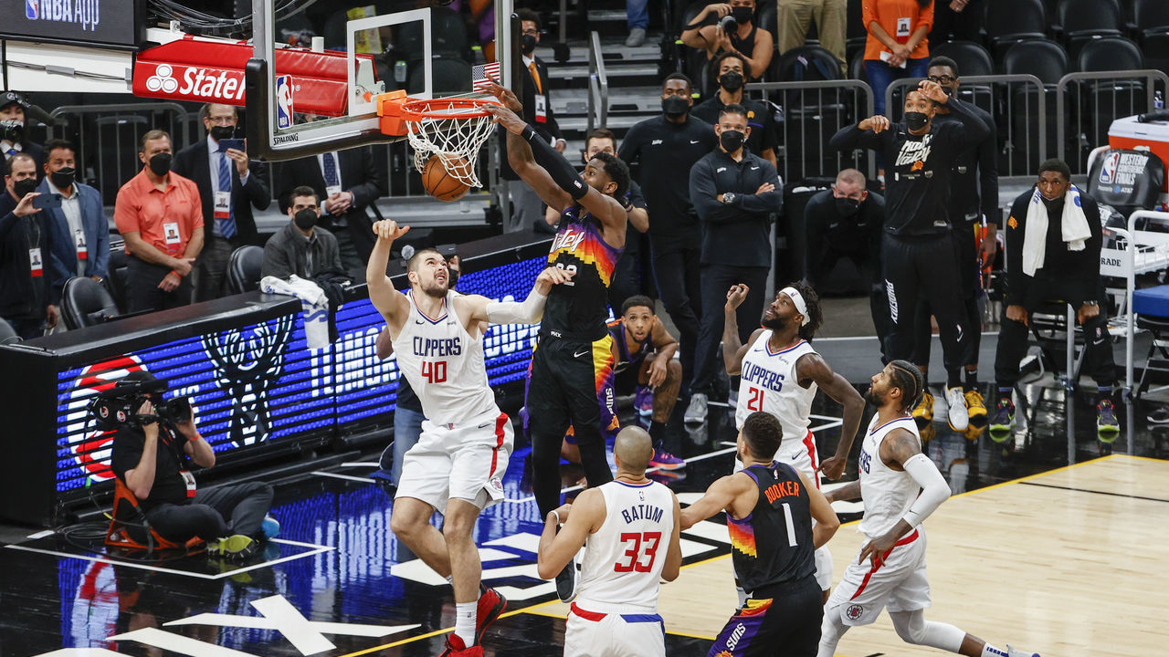 PHOENIX, ARIZONA - JUNE 22: Deandre Ayton #22 of the Phoenix Suns dunks the ball over Ivica Zubac #40 of the LA Clippers during the fourth quarter in game two of the NBA Western Conference finals in-which the Phoenix Suns defeated the LA Clippers 104-103 at Phoenix Suns Arena on June 22, 2021 in Phoenix, Arizona.