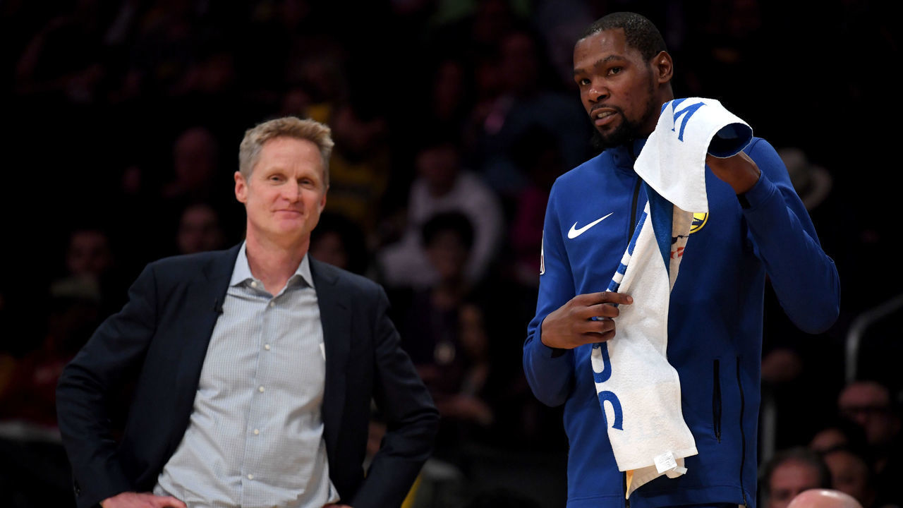LOS ANGELES, CALIFORNIA - JANUARY 21: Kevin Durant #35 and Steve Kerr of the Golden State Warriors smile courtside during a 130-111 win over the Los Angeles Lakers at Staples Center on January 21, 2019 in Los Angeles, California.