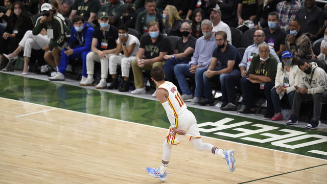 MILWAUKEE, WISCONSIN - JUNE 23: Trae Young #11 of the Atlanta Hawks celebrates a basket against the Milwaukee Bucks during the second quarter in game one of the Eastern Conference Finals at Fiserv Forum on June 23, 2021 in Milwaukee, Wisconsin.