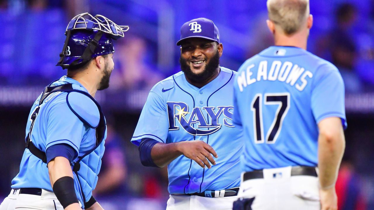 ST PETERSBURG, FLORIDA - JUNE 23: Diego Castillo #63 reacts with Mike Zunino #10 and Austin Meadows #17 of the Tampa Bay Rays after defeating the Boston Red Sox 8-2 at Tropicana Field on June 23, 2021 in St Petersburg, Florida.